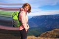 Mountain girl with pixel stretch effect at Iezer-Papusa mountains, Romania, with her hair in the wind and a big green backpack. Royalty Free Stock Photo