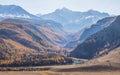 Mountain gorge and snow-capped peaks in a blue haze Royalty Free Stock Photo