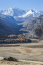 Mountain gorge and snow-capped peaks in a blue haze Royalty Free Stock Photo