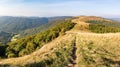 Mountain grassy ridge under blue sky in fall season