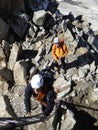 Mountain guide and client get ready to climb a ladder to the exit of their climbing route in Chamonix near Mont Blanc Royalty Free Stock Photo