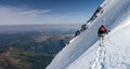 Mountain guide and client on a steep north face slope heading towards the summit with a great view of the surrounding mountain lan