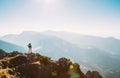 Mountain hiker with backpack tiny figurine stay on mountain peak