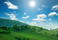 Mountain hills and green fields in sunlight on sky clouds Royalty Free Stock Photo