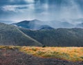 Mountain hills in the rain. Dramatic summer scene of Krasna range with old country road. Royalty Free Stock Photo