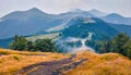 Mountain hills after the rain. Misty summer scene of Krasna range with old country road Royalty Free Stock Photo