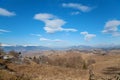 Mountain hills under blue sky with clouds in early spring. Royalty Free Stock Photo