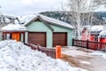 Mountain home facade with attached two car garage against cloudy sky in winter Royalty Free Stock Photo