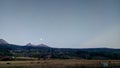 Mountain homes in the meadows below the Rocky mountains in the early morning full moon rising Royalty Free Stock Photo