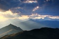 Hut at top of peak lit by sun rays at sunset Carnic Alps Italy Royalty Free Stock Photo