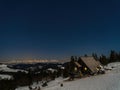 Mountain hut under a starry sky during winter snow Royalty Free Stock Photo