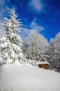 Mountain hut in winter landscape woods Royalty Free Stock Photo