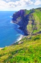 Mountain, island and ocean with green landscape, summer and calm water on peak at travel location. Nature, cliff and Royalty Free Stock Photo