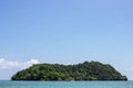 Mountain island over the sea with bright sky in background in the afternoon at Koh Mak Island in Trat, Thailand. Background. Royalty Free Stock Photo