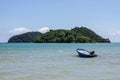 Mountain island over the sea with small boat floating over the sea and bright sky in background in the afternoon at Koh Mak Island Royalty Free Stock Photo