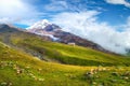 Mountain Kazbek and green valley on sunny day Royalty Free Stock Photo