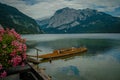 Mountain lake in Austrian Alps. beautiful view of the water surface and floating boats and kayaks Royalty Free Stock Photo