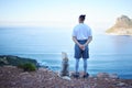 Mountain, lake and back of man with dog for hiking, walking and fresh air together outdoors. Traveling, friendship and Royalty Free Stock Photo