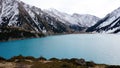 A mountain lake with blue water in winter