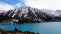 A mountain lake with blue water in winter