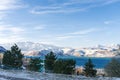 Mountain lake Charvak in Uzbekistan on a snowy frosty day, surrounded by the Tien Shan mountains. Chimgan Pyramids Royalty Free Stock Photo