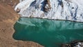 A mountain lake with emerald water is like mirror