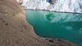 A mountain lake with emerald water is like mirror