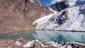 A mountain lake with emerald water is like mirror