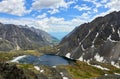 Mountain lake with floating ice in narrow valley