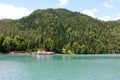 Mountain lake, houses near the water and green forest. Royalty Free Stock Photo