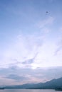 Mountain, lake, kite, blue sky and clouds