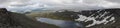 Mountain lake panorama in valley with mosses and rocks covered w