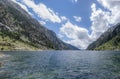 Mountain lake in the Pyrenees with the cavallers dam in the background and high mountains on the sides, Vall de Boi, Lleida, Spain Royalty Free Stock Photo