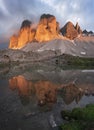 Mountain lake reflecting the mountains of the Three Peaks in the European Dolomite Alps with alpenglow during sunset, South Tyrol Royalty Free Stock Photo