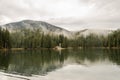 Mountain lake reserve Synevyr in the Carpathians, a rainy day with clouds in the trees Royalty Free Stock Photo