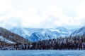 Mountain lake with rocks on the shore, winter fog over the water surface. Royalty Free Stock Photo