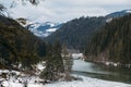 Mountain lake scenery, Lacu Rosu or Red lake and bicaz river in cloudy, rain weather, Eastern Carpathians, Romania