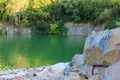 Mountain lake in the summer. Panoramic view on old flooded granite quarry with radon water.