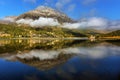 Mountain lake at sunrise in autumn. Landscape with lake, gold sunlight, blue fog over the water, reflection, trees with colorful Royalty Free Stock Photo