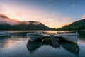 Mountain lake sunrise landscape with two traditional fishing boats Royalty Free Stock Photo