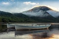 Mountain lake sunrise landscape with two traditional fishing boats Royalty Free Stock Photo