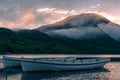 Mountain lake sunrise landscape with two traditional fishing boats Royalty Free Stock Photo