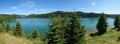 Mountain lake surrounded by green forest summer landscape