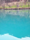 Mountain lake with turquoise blue water and old cottage