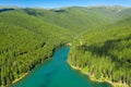 Mountain lake with turquoise water and green trees. Reflection in the water. Beautiful summer landscape with mountains, forest and Royalty Free Stock Photo