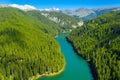 Mountain lake with turquoise water and green trees. Reflection in the water. Beautiful summer landscape with mountains, forest and Royalty Free Stock Photo