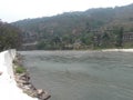 Mountain land of Bhutan with vegetation and river flowing.