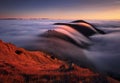 Mountain landscape above clouds at sunset in Slovakia with forest and sun Royalty Free Stock Photo