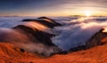 Mountain landscape above clouds at sunset in Slovakia with forest and sun Royalty Free Stock Photo