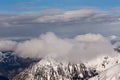 Mountain landscape in the Alps - white clouds between the peaks Royalty Free Stock Photo